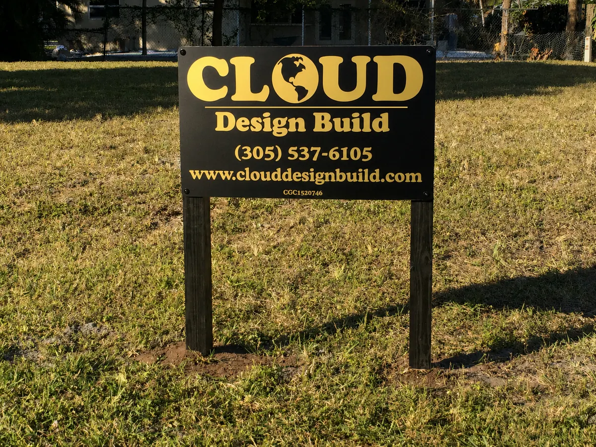 Cloud Design Build jobsite sign on a cleared lot ready for construction