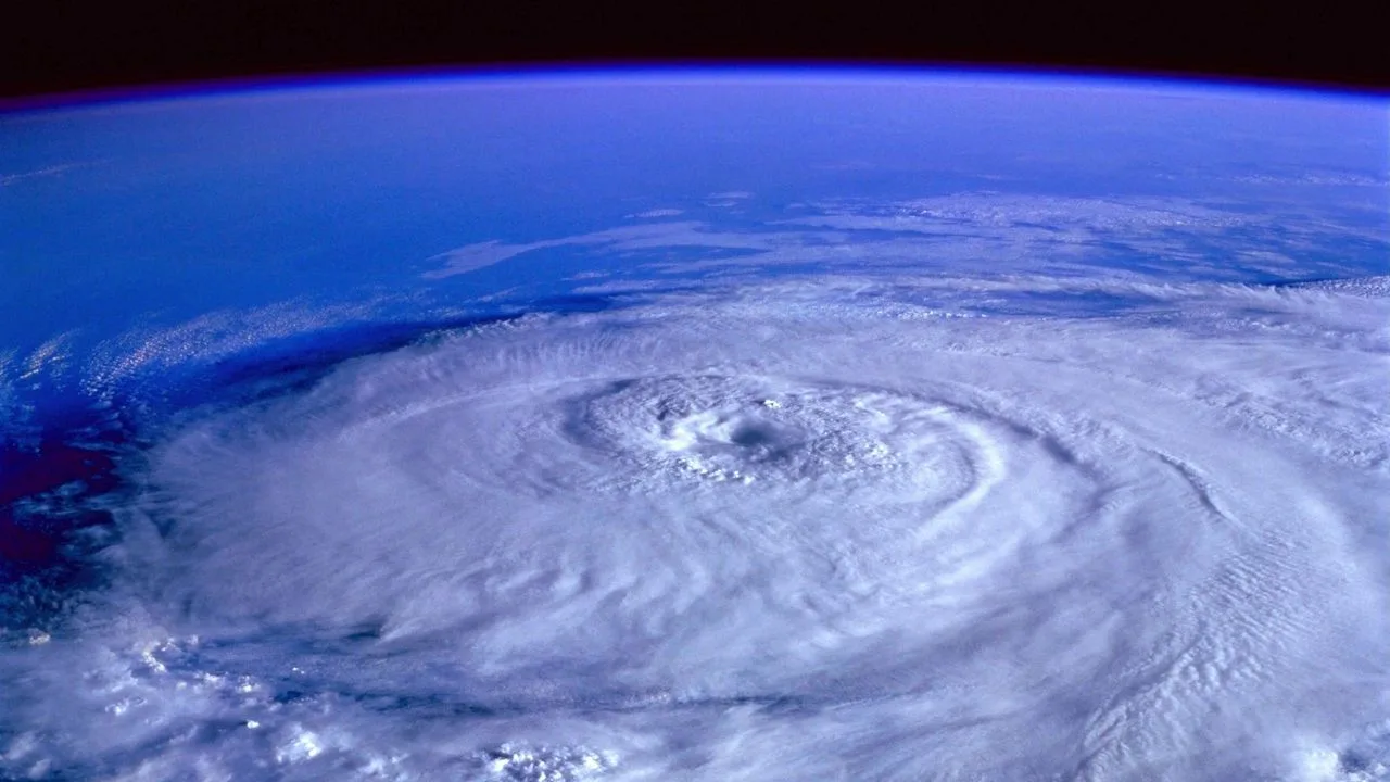 Satellite view of a hurricane's eye and spiral cloud bands over the ocean