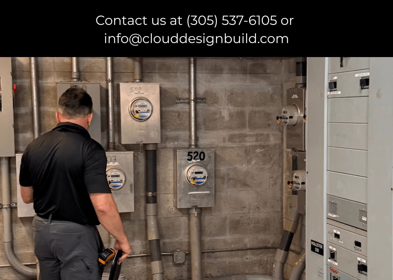Consultant inspecting electrical meters and panels in a building's mechanical room